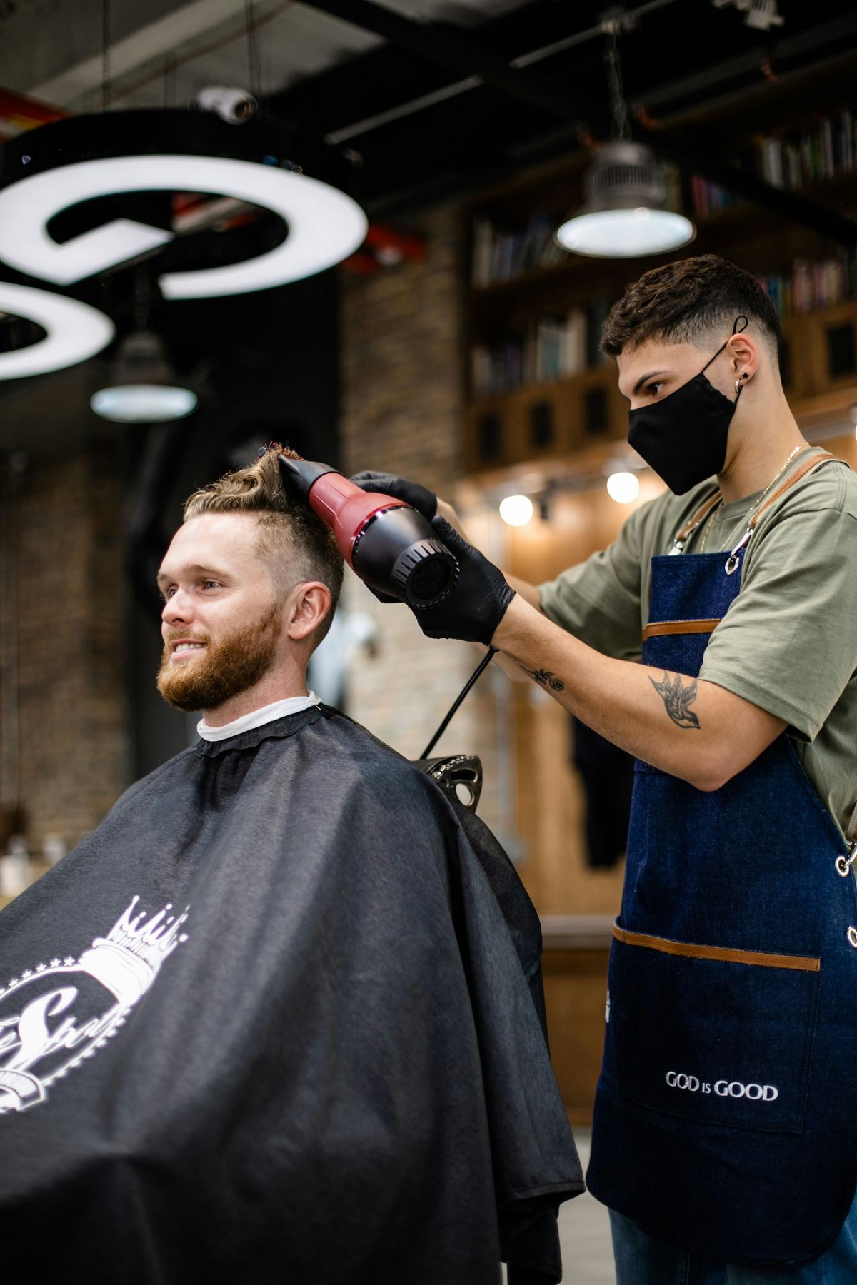 A barber drying a client's hair